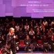 Gloria Steinem leading the theatre audience in a talking circle.